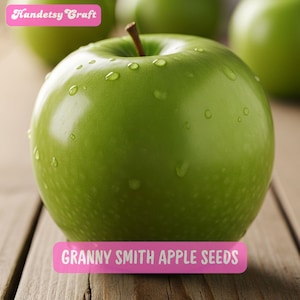 May include: A close-up of a Granny Smith apple with water droplets on its shiny green skin. The apple sits on a wooden surface. Pink labels at the top and bottom read "Handetsy Craft" and "Granny Smith Apple Seeds".