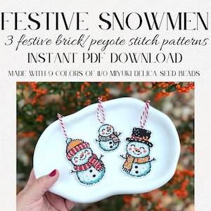 May include: Three festive snowman ornaments made with seed beads, displayed on a white dish. Each snowman has a unique hat and scarf design. The image includes text that reads "FESTIVE SNOWMEN" and "INSTANT PDF DOWNLOAD".