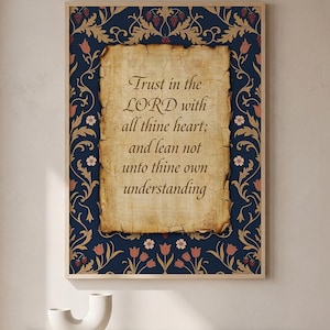 May include: Framed wall art featuring the text "Trust in the LORD with all thine heart; and lean not unto thine own understanding." The artwork has a dark blue floral border with gold and red accents, and a parchment-style background.