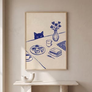 Może przedstawiać: Zestaw trzech ceramicznych kubków z nakrapianym, matowym wykończeniem. Kubki są w odcieniach kremu, jasnoszarym i ciemnoszarym. Każdy kubek ma prosty, minimalistyczny design.