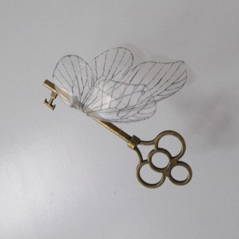 Winged flying key with large reversed wings in antique brass | Etsy
