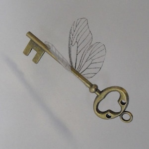 Flying winged key with small butterfly wings in antique brass - LABCVSBF