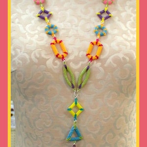 May include: A colorful beaded necklace with geometric shapes. The necklace features a variety of shapes, including circles, squares, and triangles, in shades of blue, yellow, pink, orange, and purple. The necklace is displayed on a mannequin.