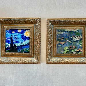 May include: Two framed art prints. One depicts a swirling night sky with a crescent moon and a dark village silhouette. The other shows a pond with lily pads and flowers. Both are in ornate gold frames.