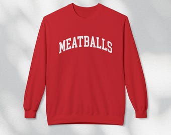 May include: Red sweatshirt with white text that reads "MEATBALLS" in an arched font.