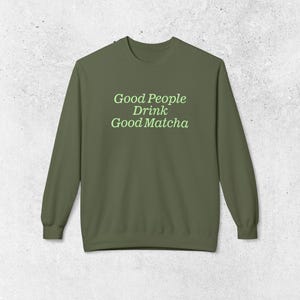 May include: A green long-sleeved sweatshirt with the text "Good People Drink Good Matcha" in light green.