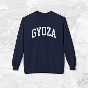 May include: Navy blue sweatshirt with a white "GYOZA" graphic in a collegiate font.