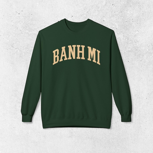 May include: A dark green sweatshirt with the text "BANH MI" in a light beige color in an arched font.