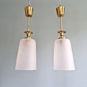 pair of Mid Century brass and crackled clear glass pendant lights, 1950s