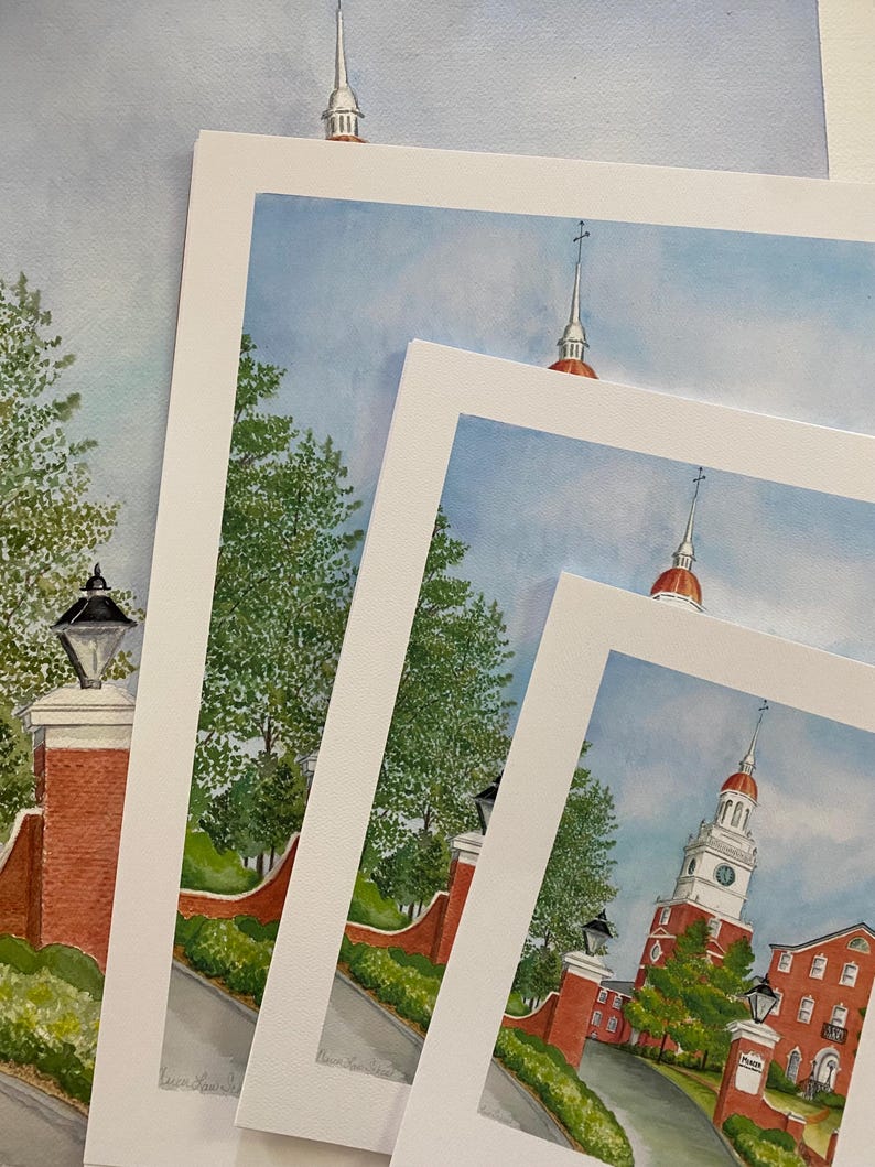 May include: Four different sizes of framed watercolour paintings of a red brick building with a white steeple and a clock tower. The building is surrounded by green trees and a brick walkway. The paintings are all signed by the artist.
