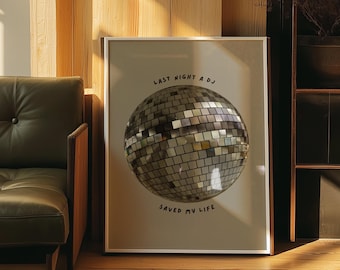 May include: A framed print with a beige background featuring a silver disco ball and the text "Last night a DJ saved my life."