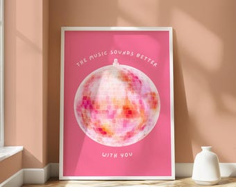 May include: Pink poster with a white disco ball and the text "The music sounds better with you".