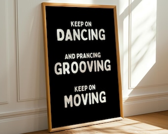 May include: Black and gold framed poster with white text that reads "Keep on Dancing and Prancing Grooving Keep on Moving".