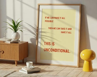 Może przedstawiać: Oprawiony plakat z jasnożółtym tłem i słowami "IF WE CAN MAKE IT ALL POSSIBLE THEN WE CAN TAKE IT AND HAVE IT ALL THIS IS UNCONDITIONAL" w kolorze czerwonym. Rama jest w kolorze jasnobrązowym.
