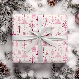 May include: White gift wrap with a pink and white Christmas tree pattern. The wrapping paper is tied with a white satin ribbon.