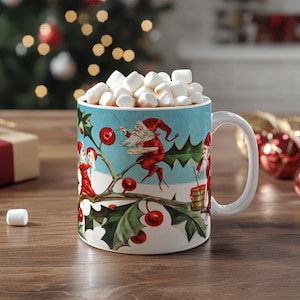May include: A white ceramic mug with a Christmas scene featuring elves and holly. The mug is filled with marshmallows and a brown liquid, suggesting hot chocolate.