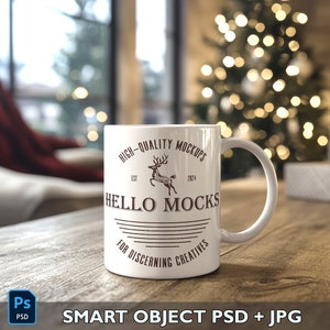 May include: White ceramic mug with a brown design that says "HIGH-QUALITY MOCKUPS EST 2024 HELLO MOCKS FOR DISCERNING CREATIVES". The mug is sitting on a wooden table with a blurred Christmas tree in the background.