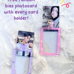 May include: Two clear plastic photo card holders with a purple and pink frame. Each holder has a cartoon animal design and a gold star charm. The text "ANITEEZ" is printed on the holders. The text "Saldeck/산" is printed on the purple holder. The text "AvirEEz" is printed on the pink holder.