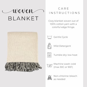 May include: A woven blanket in cream with a black and white fringe. The text "woven BLANKET" is at the top left. Care instructions are listed on the right, including gentle cycle, mild detergent, and tumble dry on low heat.