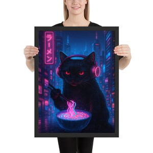 May include: Framed art print featuring a black cat with red eyes wearing headphones, enjoying ramen with chopsticks. The neon sign reads "Ramen" in Japanese. The background depicts a futuristic cityscape with neon lights.