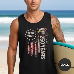 The image showcases a Comfort Colors 9360 Midweight Tank Top featuring a patriotic design. The shirt prominently displays an eagle, the years "1776" and "2026," and a distressed American flag motif. This stylish T-shirt is available in nine colors and sizes ranging from S-3XL, making it a perfect choice for celebrating American pride during Independence Day, family gatherings, or casual outings. The heavyweight fabric ensures comfort and durability, making it an ideal addition to any wardrobe.