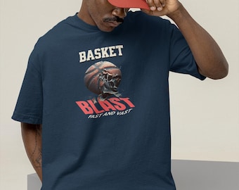 May include: Navy blue t-shirt with a basketball skull graphic. The shirt features the word "BASKET" above the graphic and "BLAST" with "FAST AND VAST" below. The person in the image is wearing a red baseball cap and khaki shorts.