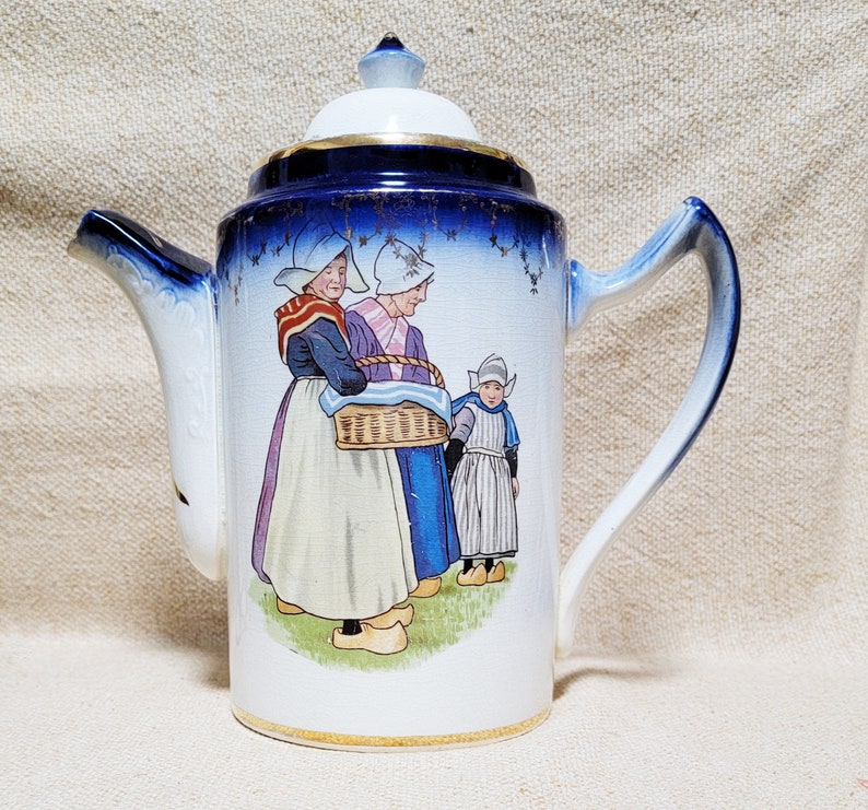 Huge early 1900's chocolate or coffee pot with Dutch figures, cobalt blue and goldtrim.