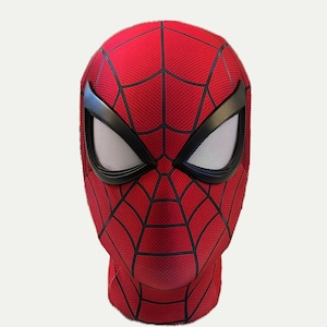 May include: A red and black Spider-Man mask with a detailed web design. The mask has a black eye mask with a white mesh design.