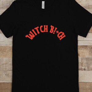 May include: Black t-shirt with a red arched graphic that says "WITCH B!+CH"