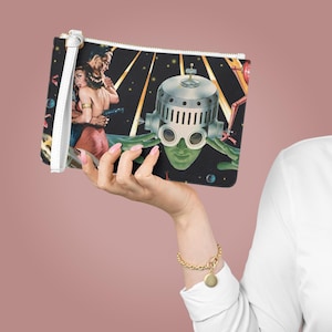Może przedstawiać: Czarno-biała torebka typu clutch z retrofuturystycznym wzorem przedstawiającym głowę robota, parę i gwiaździste niebo w tle.