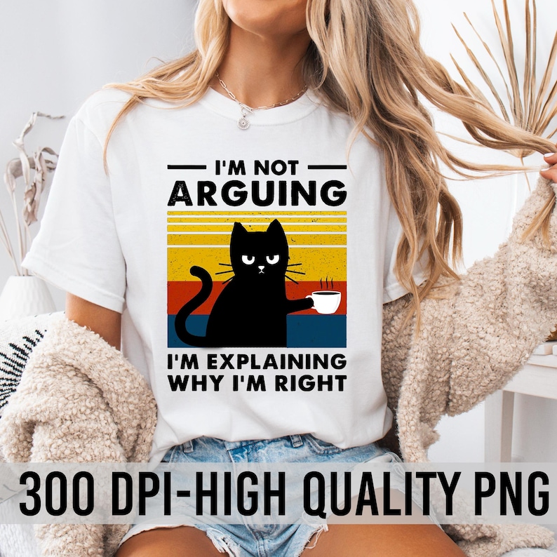 May include: White t-shirt with a black cat graphic and the text "I'm not arguing, I'm explaining why I'm right". The cat is holding a cup of coffee. The text is in a retro style font.