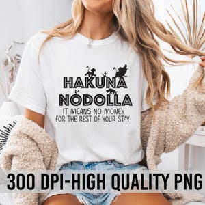 May include: White t-shirt with black text that reads "Hakuna Nodolla" and "It means no money for the rest of your stay". The text is surrounded by a silhouette of characters from the movie The Lion King.