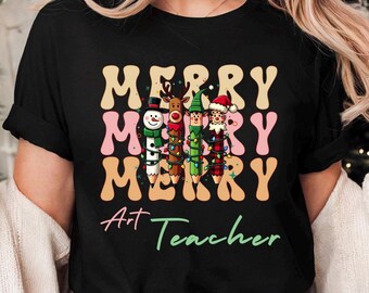 Merry Teacher Christmas Print-on-demand Tshirt is the gift for golden Art Teacher, party outfit, holiday photos, and Christmas pajamas
