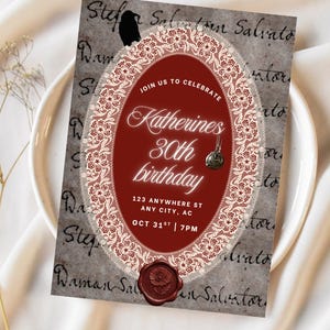 May include: A rectangular birthday invitation card featuring a dark red oval center framed by white lace. The card displays the text: JOIN US TO CELEBRATE Katherines 30th birthday 123 ANYWHERE ST ANY CITY, AC OCT 31ST | 7PM, a black raven, and a wax seal.