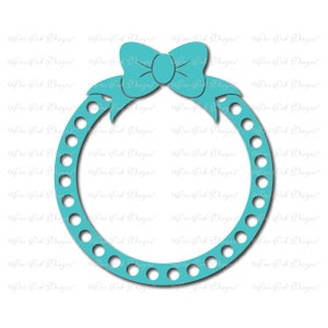 May include: A turquoise blue circle frame with a large turquoise blue bow at the top. The frame has a dotted border and is perfect for adding a photo or other embellishments.