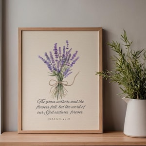 May include: A framed wall art print featuring a watercolor illustration of a lavender bouquet tied with twine. Below the flowers, the text reads: The grass withers and the flowers fall, but the word of our God endures forever. ISAIAH 40:8.