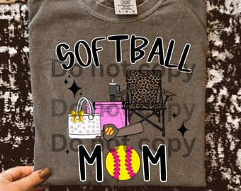 May include: A gray Comfort Colors sweatshirt with the words "SOFTBALL MOM" in black and white. The design includes a softball, a baseball bat, a bag, a chair, and a cooler.