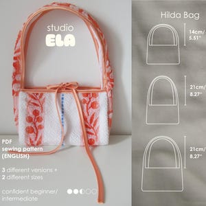 May include: A handmade tote bag with a white background and orange floral pattern. The bag has a peach-colored handle and a matching ribbon tie. The text "studio ELA" is visible. The bag's dimensions are shown as 5.51" and 8.27" in height.