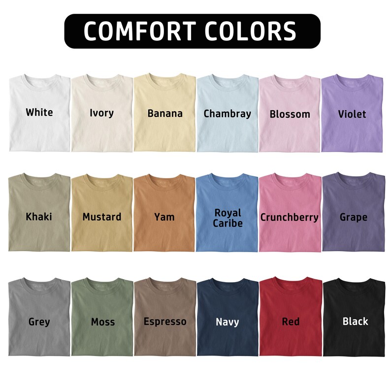 May include: A colour chart displaying eighteen t-shirts arranged in three rows of six. The text COMFORT COLORS appears at the top. Each shirt is labelled with its colour name: White, Ivory, Banana, Chambray, Blossom, Violet, Khaki, Mustard, Yam, Royal Caribe, Crunchberry, Grape, Grey, Moss, Espresso, Navy, Red, and Black.