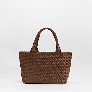 May include: A brown tote bag with woven texture. The bag has two braided handles and a rectangular shape. The bag is made of a durable material and is suitable for carrying various items.