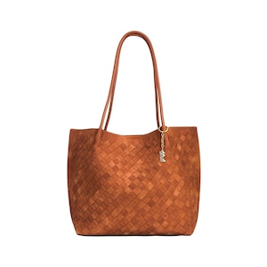 May include: A brown woven leather tote bag with long handles. The bag features a rectangular shape with a woven pattern and a small gold-colored charm hanging from the handle.