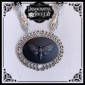 Black and silver beaded necklace deaths head moth cameo pendant hands