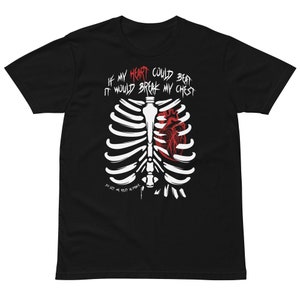 May include: Black t-shirt with a white rib cage and a red heart graphic. The text reads "IF MY HEART COULD BEAT IT WOULD BREAK MY CHEST" above the rib cage, and "SO LET ME REST IN PEACE" below.