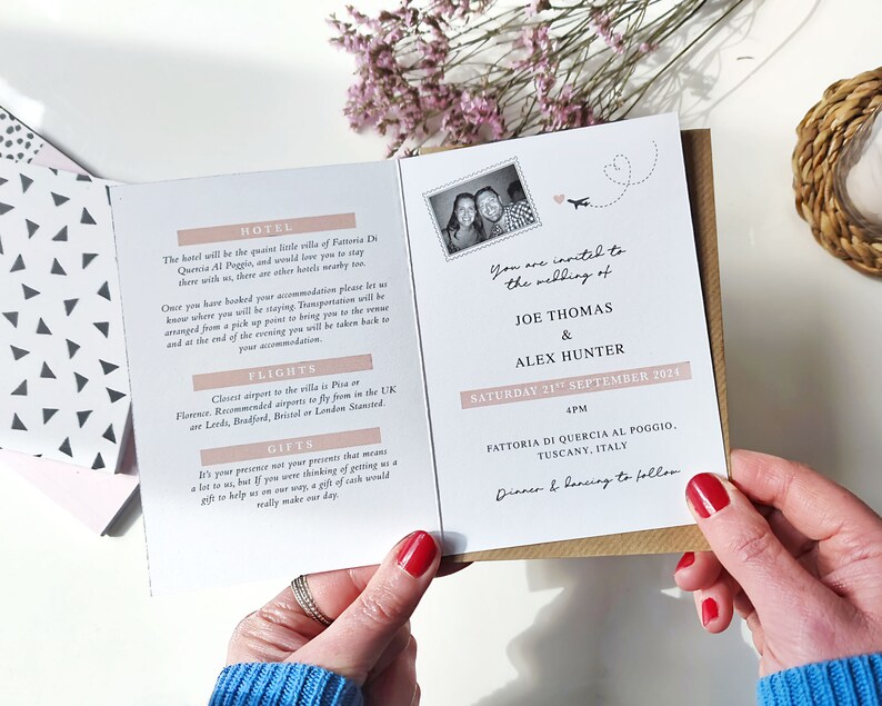 May include: A wedding invitation with a pink and white design. The invitation features a photo of the couple, a plane, and the text "You are invited to the wedding of Joe Thomas & Alex Hunter, Saturday 21st September 2024, 4pm, Fattoria di Quercia al Poggio, Tuscany, Italy, Dinner & Dancing to follow."