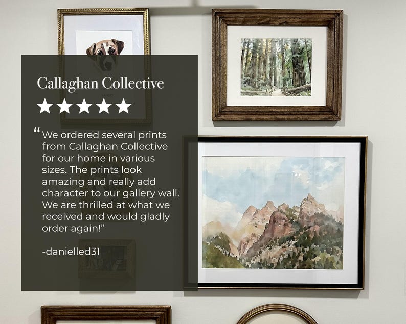 May include: A gallery wall featuring framed art prints. The prints include a dog portrait, a forest scene, and a mountain landscape. The frames are in various styles and colors, including gold and dark wood.
