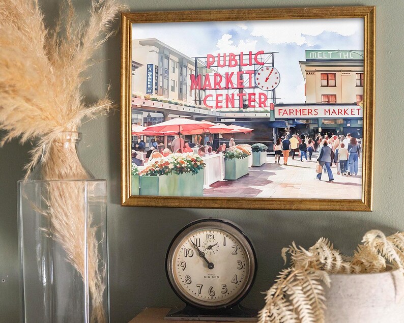 Callaghan Collective Watercolor Painting of Pike Place Market in Seattle Washington featuring the Public Market Center sign, red umbrellas, and the Farmers Market crowd, Pacific Northwest wall art for apartment or office decor.