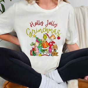 ホリージョリーグリンチマス、グリンチクリスマススウェットシャツ、グリンチマスセーター、クリスマスギフトシャツ、レトロホリデージャンパー、グリンチファミリーシャツ