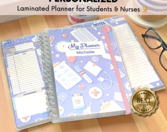 May include: A personalized, laminated planner for students and nurses. The planner features a blue cover with medical-themed illustrations, a pink elastic band, and the name "Michelle." A "Best Seller" sticker is visible.