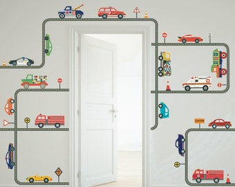 May include: A set of colorful vehicle wall decals with roads and traffic signs. The decals include a police car, fire truck, ambulance, tow truck, and other cars. The decals are perfect for a child's room or playroom.