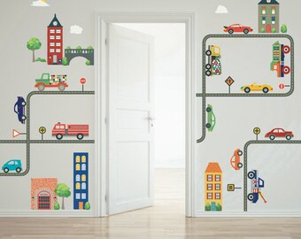 May include: A set of colorful wall decals featuring a city scene with buildings, cars, trucks, and roads. The decals are perfect for adding a playful touch to a child's room.